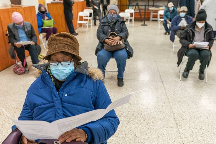 Elaine Chambers goes over a coronavirus vaccination pamphlet while resting after receiving the first dose of the vaccine at a pop-up COVID-19 vaccination site at St. Luke's Episcopal church in the Bronx on January 26th, 2021.